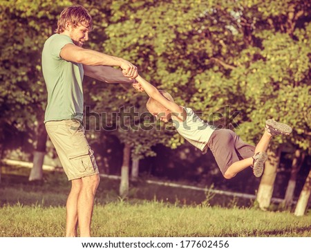 Family Father Man and Son Boy playing Outdoor Happiness emotions Lifestyle with summer nature on background