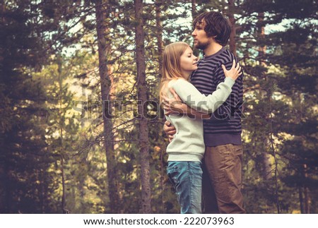 Young Couple Man and Woman Hugging in Love Romantic Outdoor with forest nature on background