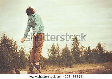 Young Man Flying levitation jumping outdoor relax Lifestyle happiness spiritual concept retro film colors trendy style