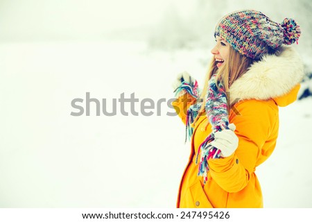 Young Woman Outdoor Winter Lifestyle happiness emotions in hat and scarf fashion clothing snow nature on background
