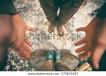 Feet Couple Man and Women in love hiking outdoor Lifestyle Travel and relationship concept river and stones on background top view