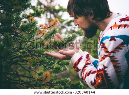 Man hands holding fir tree branch Travel Lifestyle survival concept outdoor forest nature on background