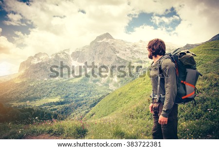 Man Traveler with backpack hiking Travel Lifestyle concept mountains on background Summer journey adventure vacations outdoor