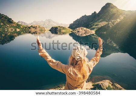Woman Traveler meditating harmony with nature Travel healthy Lifestyle concept lake and rocky mountains landscape on background outdoor