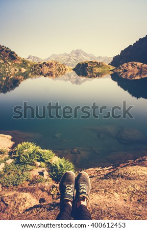 Feet Selfie Traveler relaxing with lake and mountains view on background Lifestyle hiking Travel concept summer vacations adventure outdoor