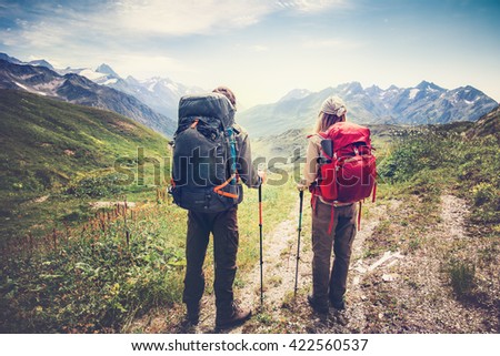 Couple Man and Woman Travelers backpackers mountaineering Travel Lifestyle and relationship love concept mountains landscape on background