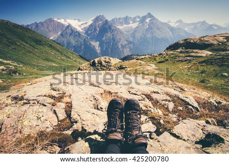 Feet trekking boots hiker with mountains landscape outdoor Travel Lifestyle concept active Summer vacations adventure