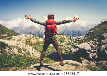 Traveler Man with backpack jumping hands raised mountains landscape on background Lifestyle Travel happy emotions success concept summer vacations outdoor