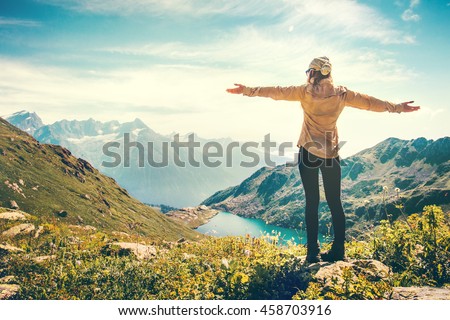 Happy Woman Traveler raised hands mountains and lake landscape on background Travel Lifestyle concept adventure summer vacations