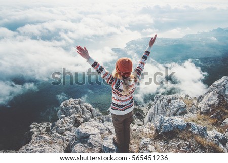 Happy woman traveler on mountain summit hands raised over clouds Travel Lifestyle success concept adventure active vacations outdoor harmony with nature