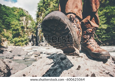 Feet trekking boots hiking Traveler alone outdoor wild nature Lifestyle Travel extreme survival concept summer adventure vacations steps sole view from below