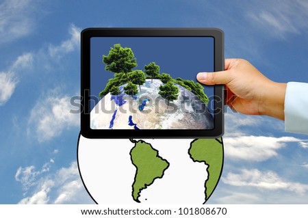 Hand holding tablet PC with  tree on earth globe