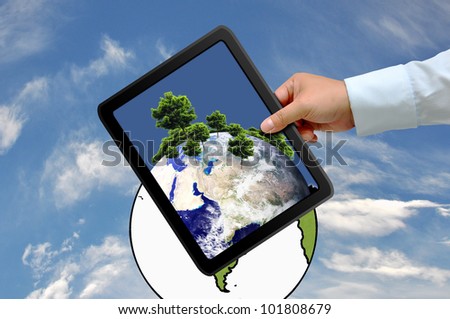 Hand holding tablet PC with  tree on earth globe