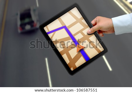 Male hand holding a touchpad gps