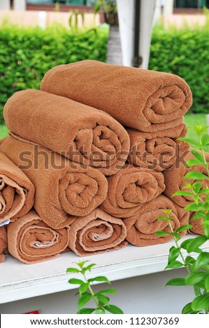 Brown towels roll neatly for pool side use