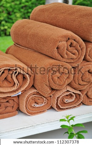 Brown towels roll neatly for pool side use