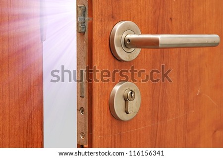 Modren style door handle on natural wooden door with white light
