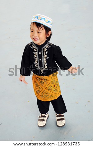 Portrait of asian boy with smile in malaysia dress