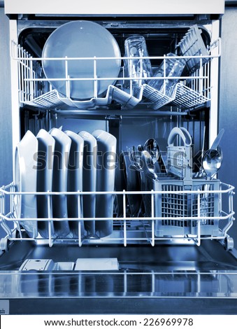 Inside a dishwasher and dishes in the kitchen.