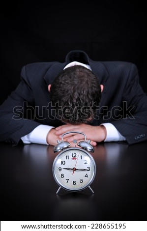 Businessman is wasting time concept on the black background