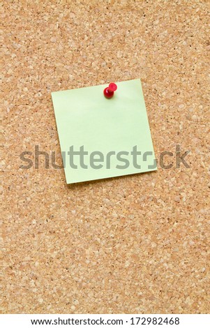 blank post it note pinned to a cork board / bulletin board