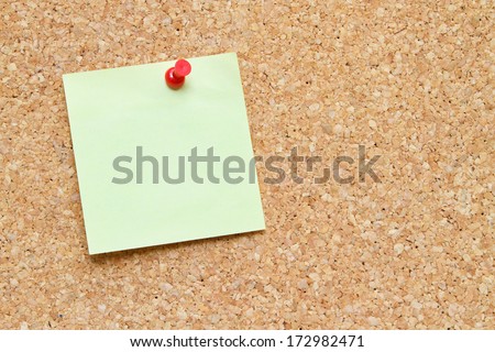blank post it note pinned to a cork board / bulletin board