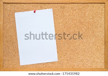 blank piece of white A4 paper pinned to a cork board / bulletin board with a wooden frame