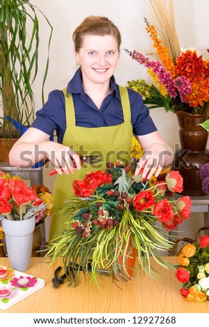 Young Florist in shop preparing flower decoration
