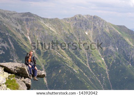 http://image.shutterstock.com/display_pic_with_logo/91974/91974,1214906369,1/stock-photo-young-male-is-sitting-on-the-edge-of-a-precipice-in-tatra-mountains-14392042.jpg
