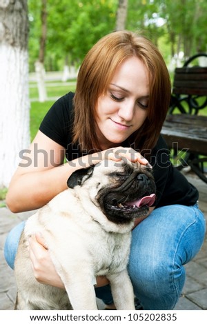girl with smile on person irons hand its dog