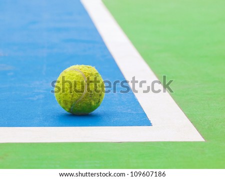 used tennis ball on the corner of sport court