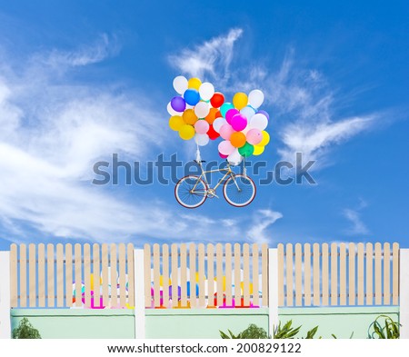 fence and balloons with bicycle on blue sky