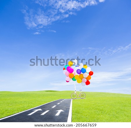 balloon and bicycle on the road with blue sky background