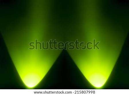 green light of torch flashlight on dark screen