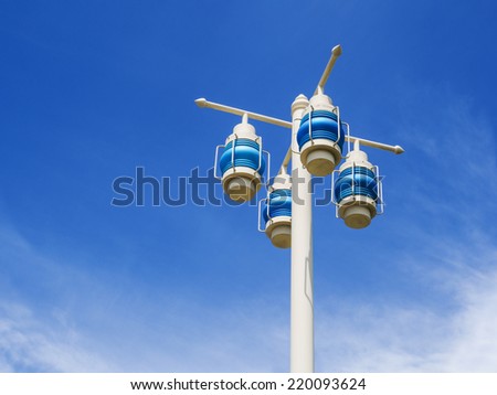 electric lighting lamps on the pole on blue sky background
