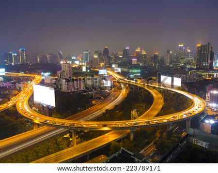 cityscape in the night showing many building and street light on a Express Way of Bangkok, Thailand