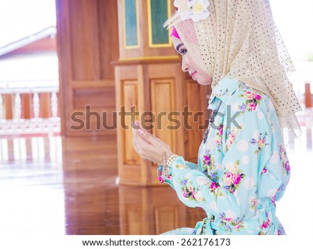 young muslim woman praying for Allah, muslim God