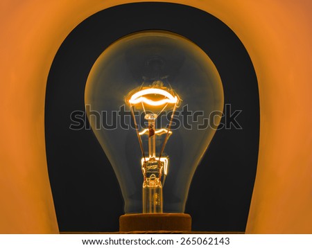 glowing light bulb by electrical current in metal filament