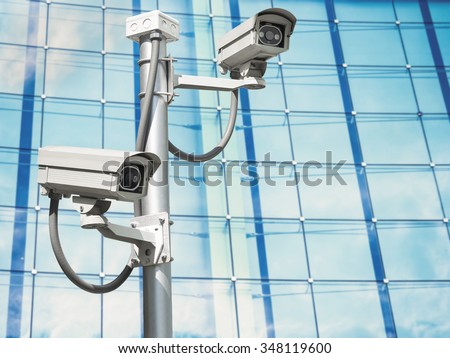 cctv installed on the wall on window glass of building , outdoor security