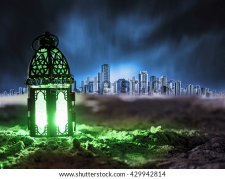 Lantern lighting with candle shining on sand ground, children play with it in Ramadan night, also known and called ramadan lantern