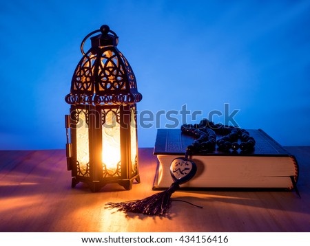 candle light of muslim style\'s lantern shining on arabic letter of the name of Muslim Prophet \