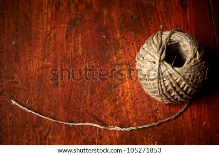 Skein of jute twine on the wooden background