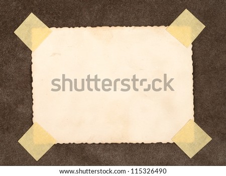 Reverse side of an old photo print with a decorative border on brown background