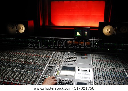 hand on mixer in the recording studio