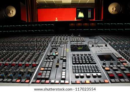 Low angle shot of a mixing desk in music studio