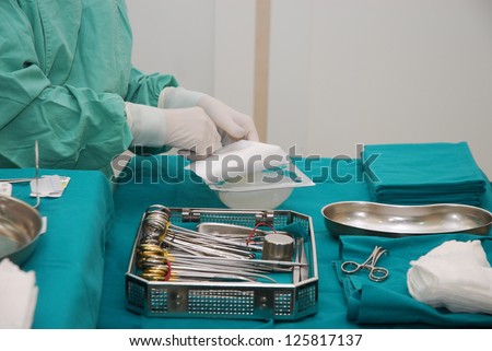 Nurse with operating tools and chest implants