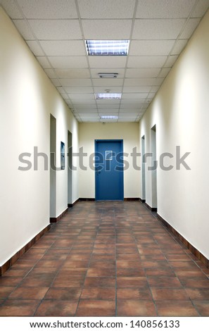 empty long corridor in the modern office building empty long corridor in the modern office building