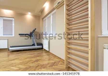 Wall bars and running treadmill in exercise room
