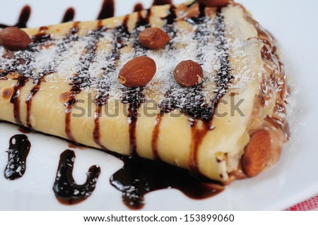 crepes with chocolate syrup and almond