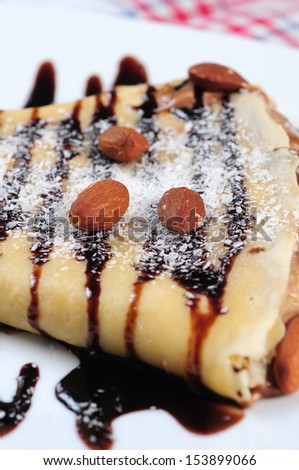 crepes with chocolate syrup,almond and coconut